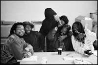 a group of men with dreadlocks sitting around a table