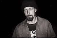 a black and white photo of a man with a beard