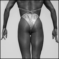 a black and white photo of a woman in a bikini