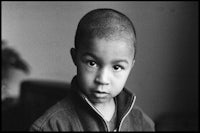 a black and white photograph of a young boy