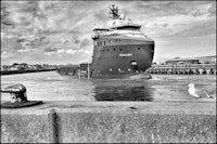 a black and white photo of a large ship in the water
