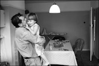 black and white photograph of a man and his daughter in a kitchen