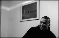 a black and white photo of a man smiling